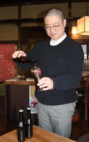 試作の商品をそそぐ社長