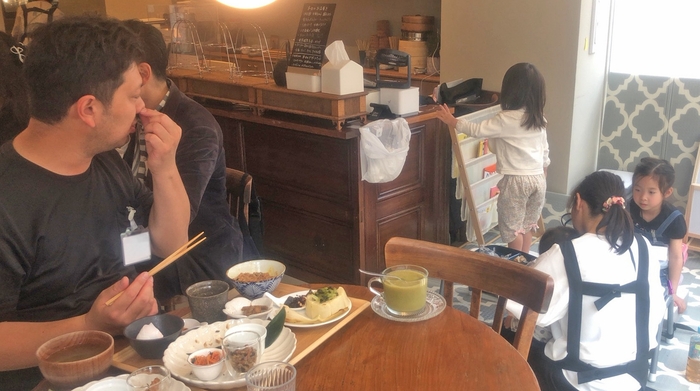 子どもをスタッフに任せて食事をするパパの様子