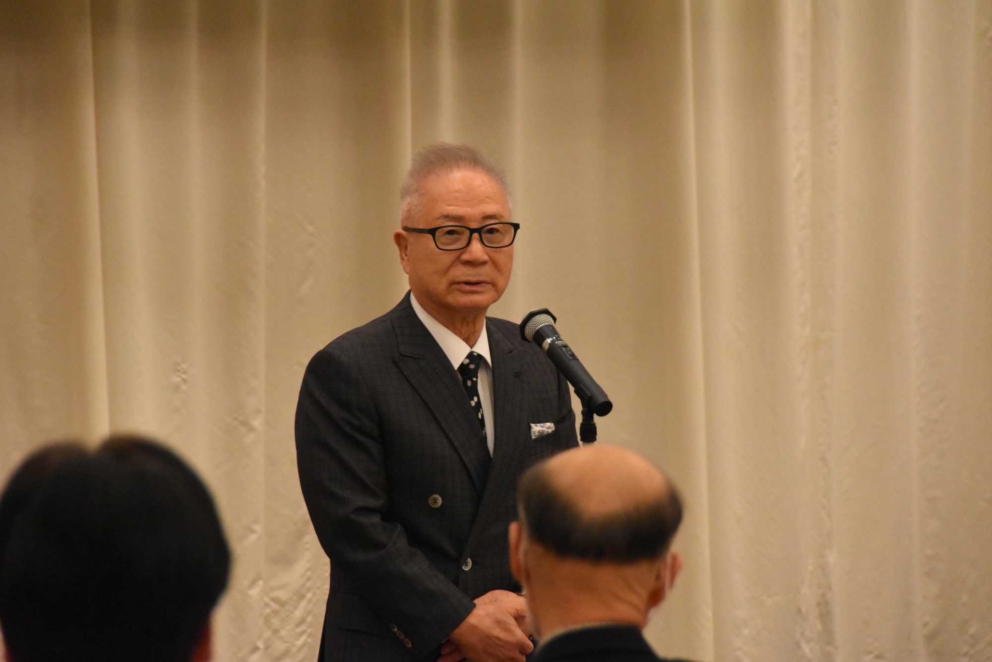 挨拶する谷会長