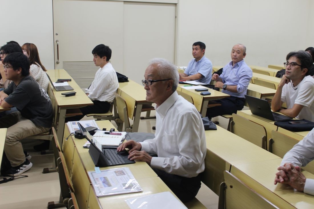 学生たちの報告に聞き入る宮下客員教授(中央)ら