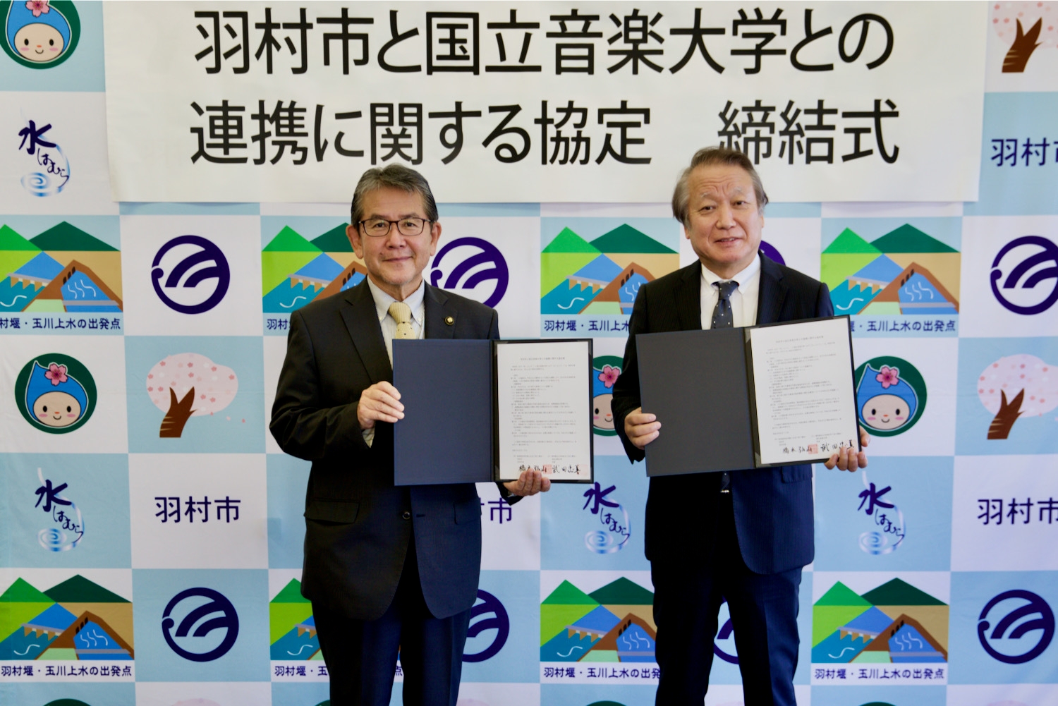 締結式にて 羽村市長:橋本 弘山(左)、学長:武田 忠善(右)