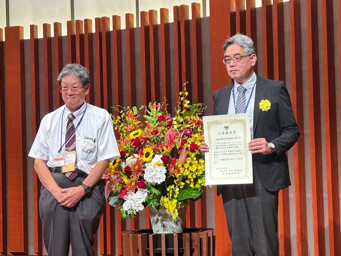 日本工学教育協会の岩附信行会長(左)から表彰状を授与された赤木教授(右)