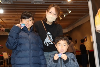 完成したアンモナイトの化石レプリカを手に笑顔の子どもたち