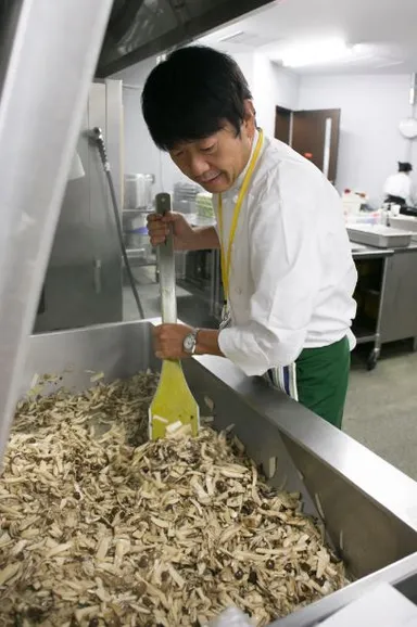 大日本印刷株式会社の厨房で調理する笹島 保弘シェフ