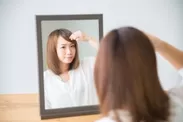 画像1.前髪を整えている女性