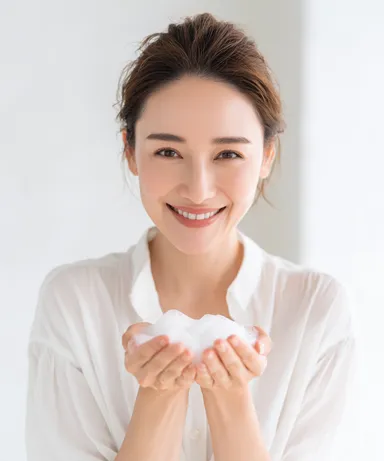 泡を手に持った笑顔の女性