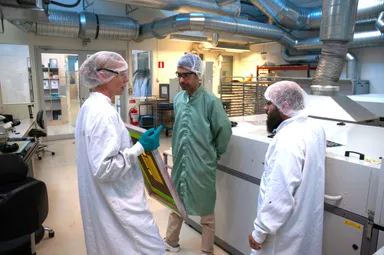 クリーンルーム内でプリンテッドエレクトロニクス向けの新規材料開発と評価を行う研究者たち