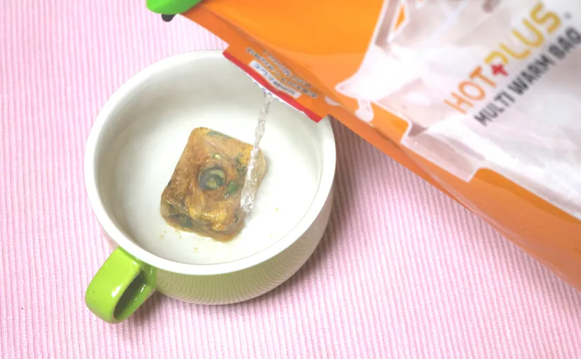 「HOTPLUS マルチウォームバッグ」で確保したお湯を使い、離乳食を準備する様子