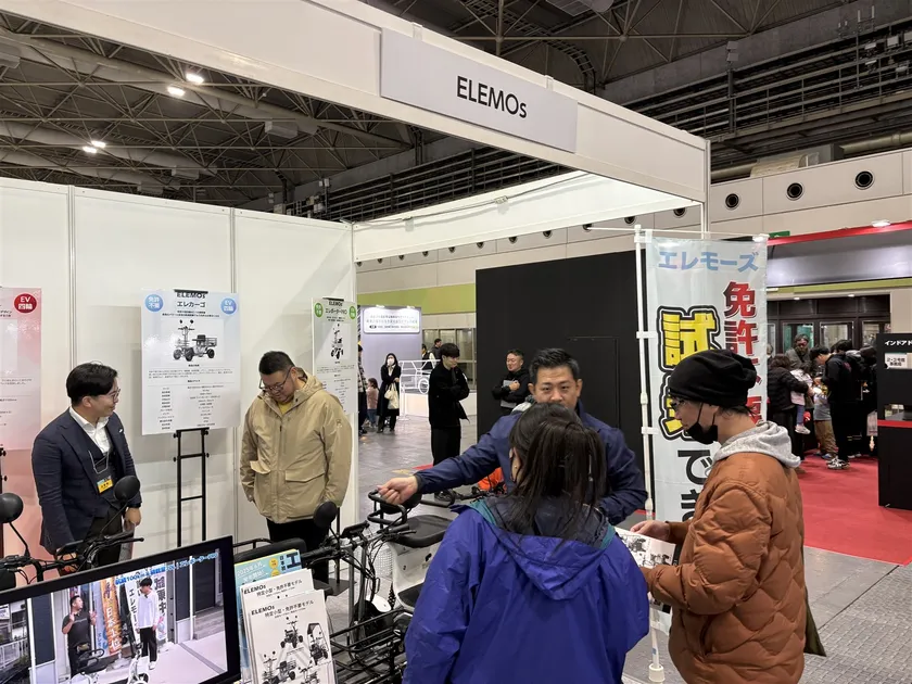 ジャパンモビリティショー関西2025(大阪モーターショー)のELEMOsブース。スタッフが来場者に製品を案内